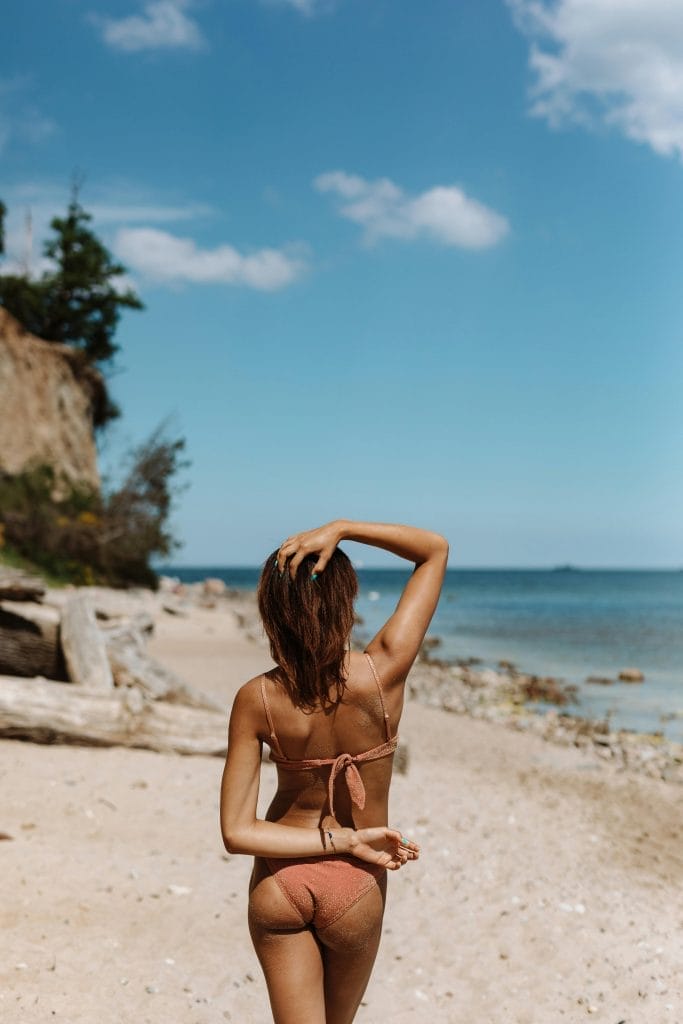 A woman on the beach in a bikini.